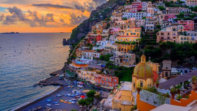 A gorgeous sunset overlooking Positano, Italy on the Amalfi Coast.